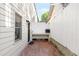 Side yard features brick patio with a grill station and white fence at 383 6Th Ne St # 4, Atlanta, GA 30308
