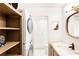 Bathroom features white tile, washer/dryer and vanity with drawers and bronze fixtures at 383 6Th Ne St # 4, Atlanta, GA 30308