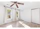 Sunlit bedroom with neutral walls, ceiling fan and two windows with backyard views at 383 6Th Ne St # 4, Atlanta, GA 30308