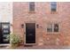 Brick townhouse with a front door and black hardware, complemented by a charming brick driveway at 383 6Th Ne St # 4, Atlanta, GA 30308