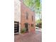 Brick townhouse featuring a front door with black hardware and a well-maintained brick driveway at 383 6Th Ne St # 4, Atlanta, GA 30308