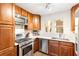 Bright kitchen with stainless steel appliances, gas range, wood cabinets and modern countertops at 383 6Th Ne St # 4, Atlanta, GA 30308