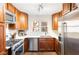 Modern kitchen with stainless steel appliances, light countertops, and wood cabinets at 383 6Th Ne St # 4, Atlanta, GA 30308