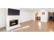 Open-concept living room with hardwood floors, a fireplace, and views into the kitchen at 383 6Th Ne St # 4, Atlanta, GA 30308
