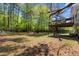 Expansive backyard featuring a spacious deck, mature trees, and a lush lawn at 3898 Hadley Farm Dr, Marietta, GA 30066