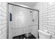 Updated shower featuring white subway tile walls and dark, honeycomb tile floor at 3898 Hadley Farm Dr, Marietta, GA 30066
