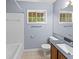 Bathroom featuring a tub shower, oak vanity and a large mirror at 3898 Hadley Farm Dr, Marietta, GA 30066