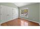 Bedroom with double closets, hardwood floors, and a large window at 3898 Hadley Farm Dr, Marietta, GA 30066