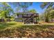 Back exterior of home with large deck and grassy backyard at 3898 Hadley Farm Dr, Marietta, GA 30066