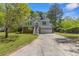 Charming two-story home with landscaped yard and a two-car garage and long driveway on a sunny day at 3898 Hadley Farm Dr, Marietta, GA 30066