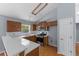 Well-lit kitchen features stainless steel appliances, plenty of cabinets and bar seating on hardwood floors at 3898 Hadley Farm Dr, Marietta, GA 30066
