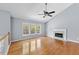 Bright living room with hardwood floors, a fireplace and large windows offering ample natural light at 3898 Hadley Farm Dr, Marietta, GA 30066