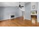 Open living room featuring a fireplace, hardwood floors, and access to the kitchen area at 3898 Hadley Farm Dr, Marietta, GA 30066