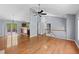 Open concept living room with hardwood floors, leading to kitchen and a staircase at 3898 Hadley Farm Dr, Marietta, GA 30066