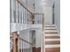 View of the staircase with wood railing and hardwood steps leading to the upper level of the home at 3898 Hadley Farm Dr, Marietta, GA 30066