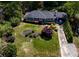 Aerial view featuring a home with a well-maintained lawn, landscaping, a carport, and a long driveway at 4519 Sims Ct, Tucker, GA 30084