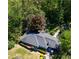 Overhead view of a well-kept house surrounded by lush trees, greenery, and manicured lawns at 4519 Sims Ct, Tucker, GA 30084