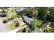 Aerial view showcasing a home's layout, landscaping, and surrounding neighborhood with mature trees and green lawns at 4519 Sims Ct, Tucker, GA 30084