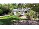 Extensive backyard boasting a wooden deck, mature trees, lush greenery, and comfortable seating at 4519 Sims Ct, Tucker, GA 30084
