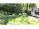 Serene backyard featuring lush landscaping, a charming garden shed, and inviting seating areas at 4519 Sims Ct, Tucker, GA 30084