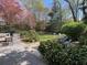 Landscaped backyard featuring mature trees, well-manicured lawn, a deck, and outdoor seating at 4519 Sims Ct, Tucker, GA 30084