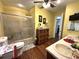 Well-lit bathroom features a shower, toilet, vanity and hardwood floors at 4519 Sims Ct, Tucker, GA 30084