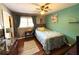 Cozy bedroom features hardwood floors, a window with curtains, and natural light at 4519 Sims Ct, Tucker, GA 30084