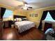 Cozy bedroom with a large window and hardwood flooring at 4519 Sims Ct, Tucker, GA 30084