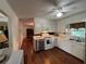 Well-lit kitchen features white cabinets, stainless steel appliances, and hardwood floors at 4519 Sims Ct, Tucker, GA 30084