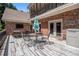Outdoor deck with brick siding, a patio table, chairs and a view of the two-story home at 1935 Northbrooke Ln, Atlanta, GA 30338