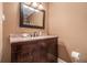 Bathroom vanity with granite countertop, dark wood cabinets and brushed nickel faucet at 1935 Northbrooke Ln, Atlanta, GA 30338