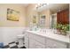Updated bathroom offers a classic black-and-white tiled floor, white vanity and ample lighting at 1935 Northbrooke Ln, Atlanta, GA 30338
