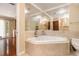 Bright bathroom showcasing a corner soaking tub, tiled walls, and picture frame mirror at 1935 Northbrooke Ln, Atlanta, GA 30338