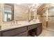 Bathroom featuring a double sink vanity, tiled walls, walk-in shower and a mirror at 1935 Northbrooke Ln, Atlanta, GA 30338