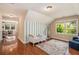 Charming Bedroom with hardwood floors, bright window, and a whimsical striped accent wall at 1935 Northbrooke Ln, Atlanta, GA 30338