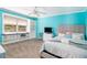 Bright blue bedroom with a cozy window seat, a ceiling fan, and plenty of natural light at 1935 Northbrooke Ln, Atlanta, GA 30338