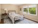 Cozy bedroom featuring a wrought iron bed, a large window, and a vintage-style area rug at 1935 Northbrooke Ln, Atlanta, GA 30338
