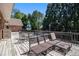 A spacious wooden deck featuring a lounger and dining table provides the perfect setting for outdoor relaxation at 1935 Northbrooke Ln, Atlanta, GA 30338