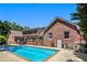 A beautiful brick home with a large in-ground pool, deck, and lush landscaping at 1935 Northbrooke Ln, Atlanta, GA 30338