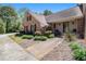 Inviting front entrance with brick accents, lush landscaping, and a cozy seating area at 1935 Northbrooke Ln, Atlanta, GA 30338