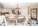 Bright kitchen featuring a checkered floor, stylish table, and stainless steel appliances at 1935 Northbrooke Ln, Atlanta, GA 30338