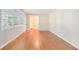 Bedroom featuring hardwood floors, a window, and view to the hallway at 2480 Warwick Ne Cir, Atlanta, GA 30345