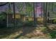 Brick home featuring a carport, situated among trees at dusk at 2480 Warwick Ne Cir, Atlanta, GA 30345