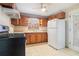 Kitchen featuring knotty pine cabinets, an updated stove, and a white refrigerator at 2480 Warwick Ne Cir, Atlanta, GA 30345