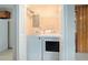 Bright laundry room featuring a washer and dryer with shelving for storage convenience at 2480 Warwick Ne Cir, Atlanta, GA 30345