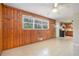 Living room with wood paneling and view into the kitchen area at 2480 Warwick Ne Cir, Atlanta, GA 30345