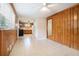 Living room with wood paneling and view into the kitchen area at 2480 Warwick Ne Cir, Atlanta, GA 30345