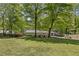 Spacious backyard with a lush lawn, patio area, and mature trees creating a private oasis at 2574 Warwick Dr, Marietta, GA 30062