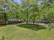 Large, well-maintained backyard with patio, mature trees, and lush green lawn at 2574 Warwick Dr, Marietta, GA 30062