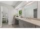 Elegant bathroom featuring a large mirror, granite countertop, and wood-look tile flooring at 2574 Warwick Dr, Marietta, GA 30062